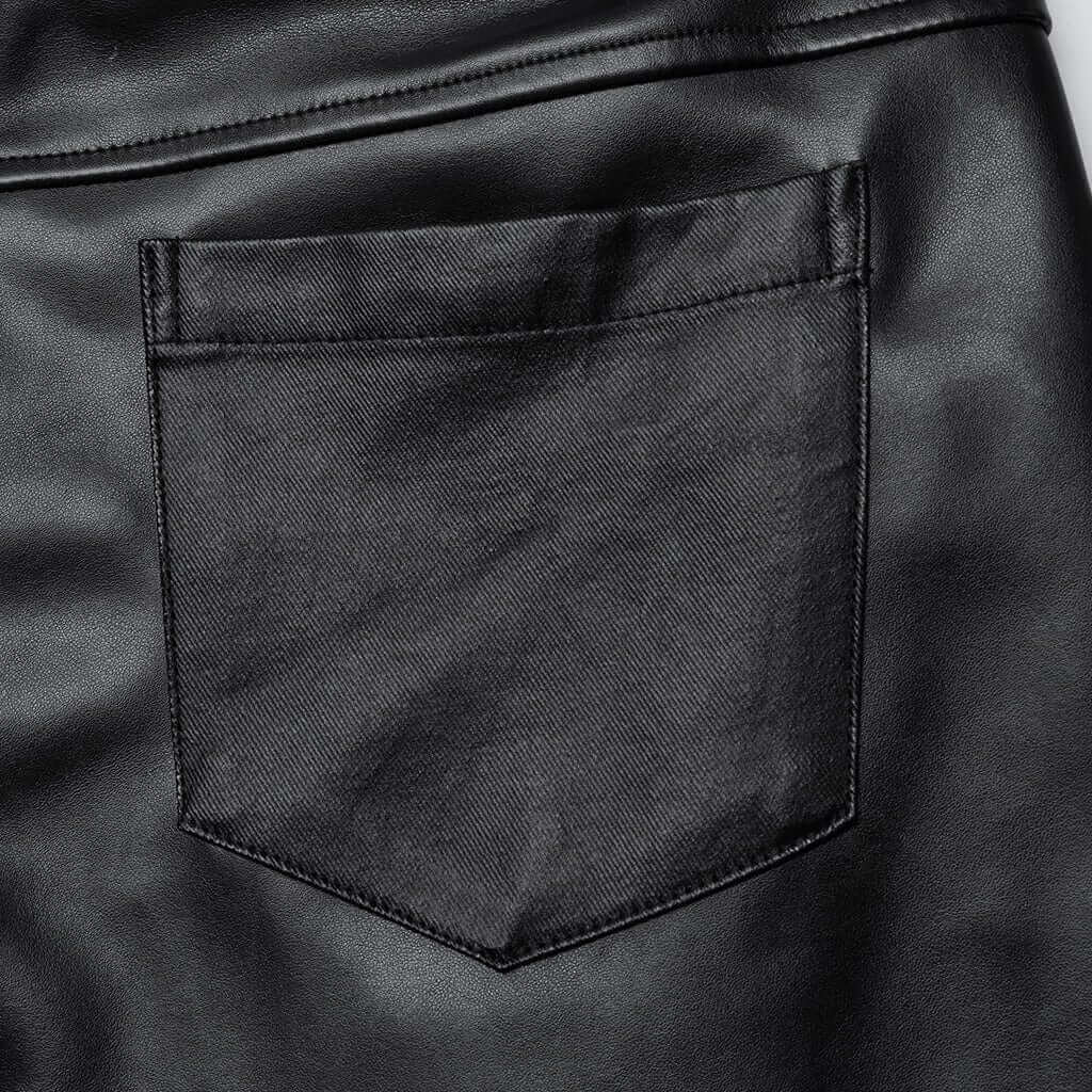 Close-up view of the back pocket on Mordanthe Trousers, showcasing sleek black fabric and detailed stitching.