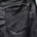 Close-up view of the back pocket on Mordanthe Trousers, showcasing sleek black fabric and detailed stitching.
