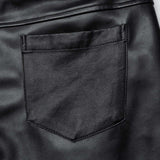 Close-up view of the back pocket on Mordanthe Trousers, showcasing sleek black fabric and detailed stitching.