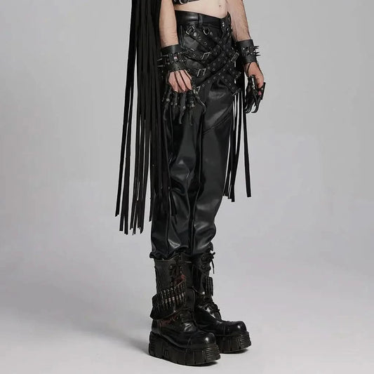 Mordanthe Trousers featuring stylish black faux leather, fringe details, and edgy accessories, perfect for bold fashion statements.